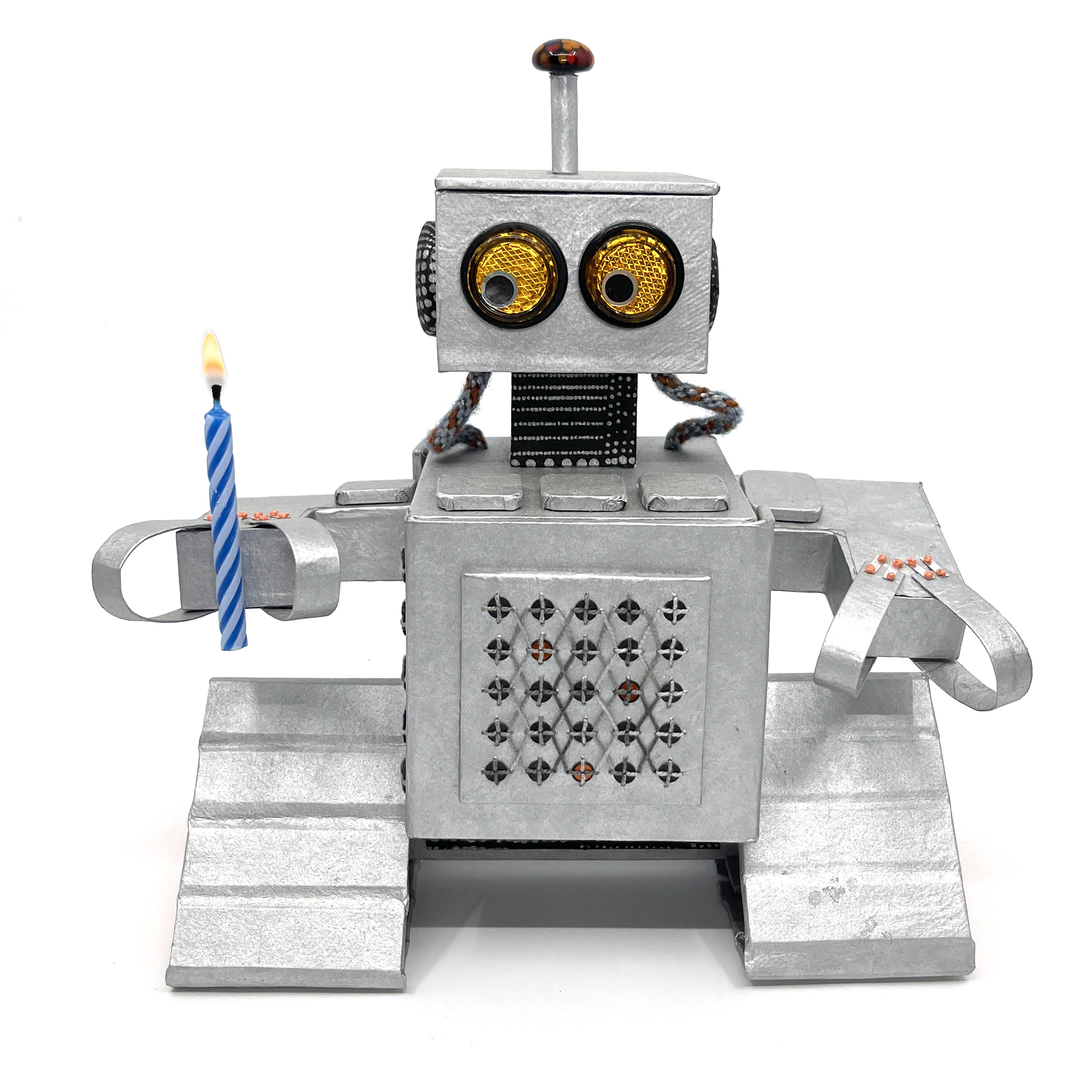 Milo the robot holding a lit birthday candle